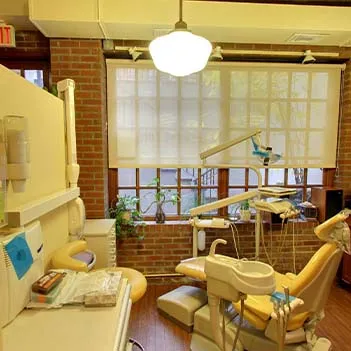 A sunlit treatment room with brick walls